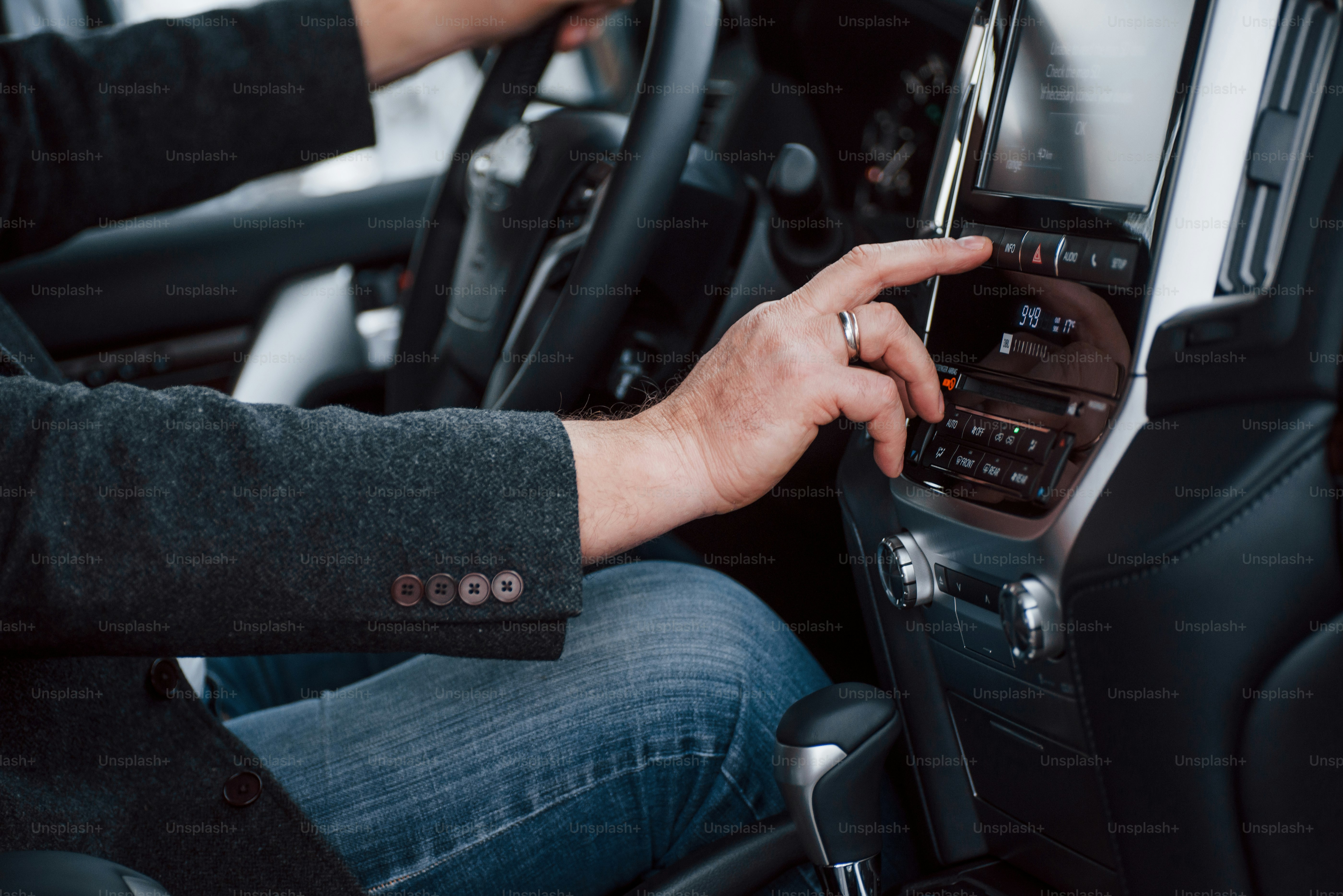 Disattivazione di funzioni speciali. Uomo d'affari prova la sua nuova auto moderna. Interni di lusso neri di un bel veicolo.