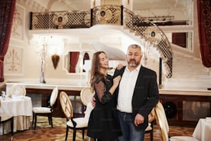 Picture of grandfather with his granddaughter in aristocratic place.
