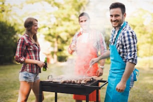 Happy people having camping and having bbq party outdoor