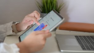 Woman checking inbox emails at office on digital tablet computer