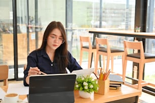 Asian women working on co working space.