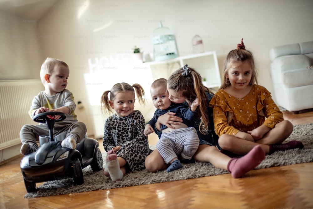 Their smiles on the faces everything says. Group of children at home.