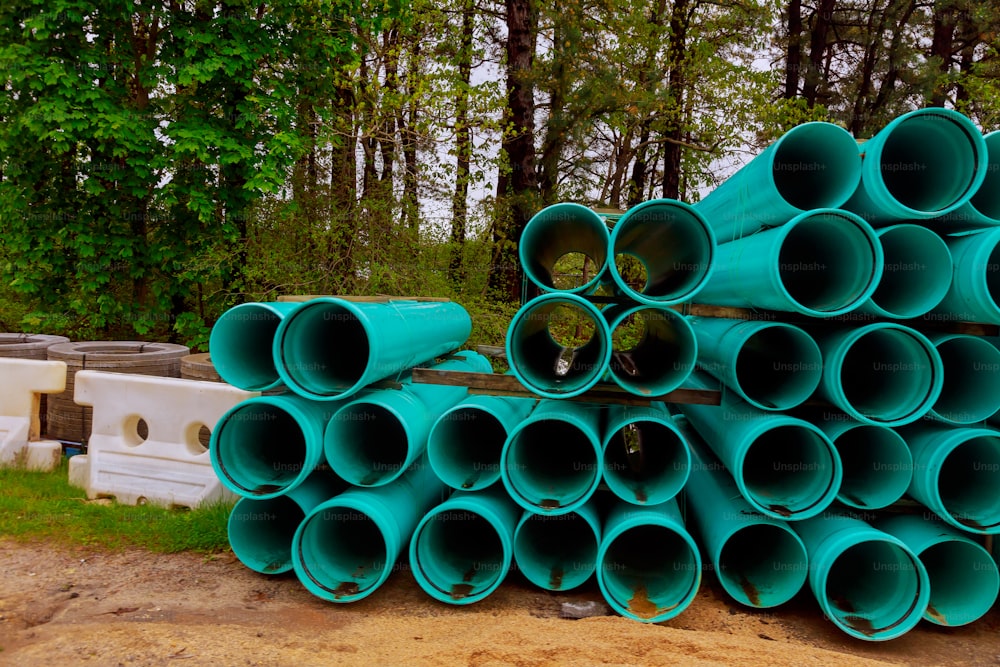 Pallets of green sewer PVC pipes at construction for drainage system