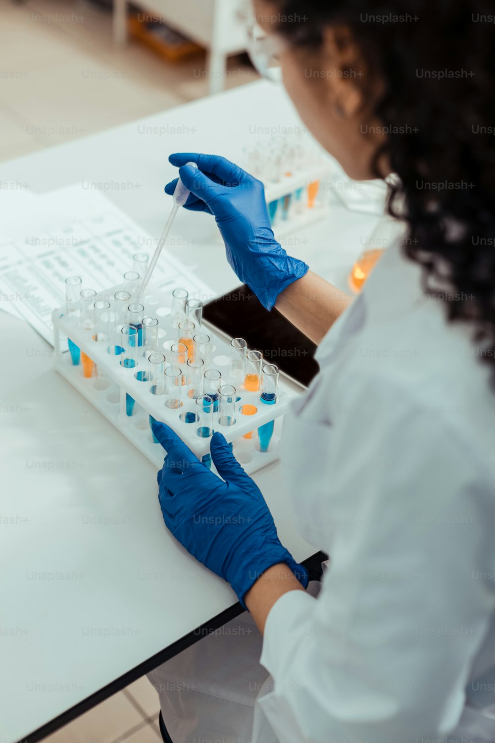 Scientific laboratory. Top view of test tubes being in use by a smart skilled scientist in the laboratory