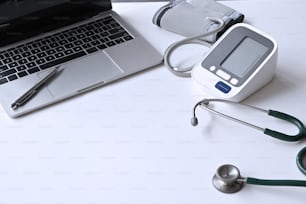 Medical equipment and Laptop computer on Doctor workspace.