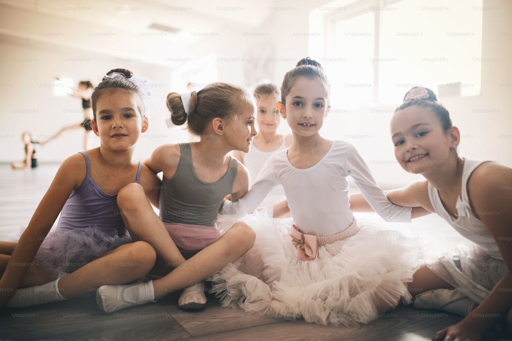 Group of fit children exercising ballet in studio together