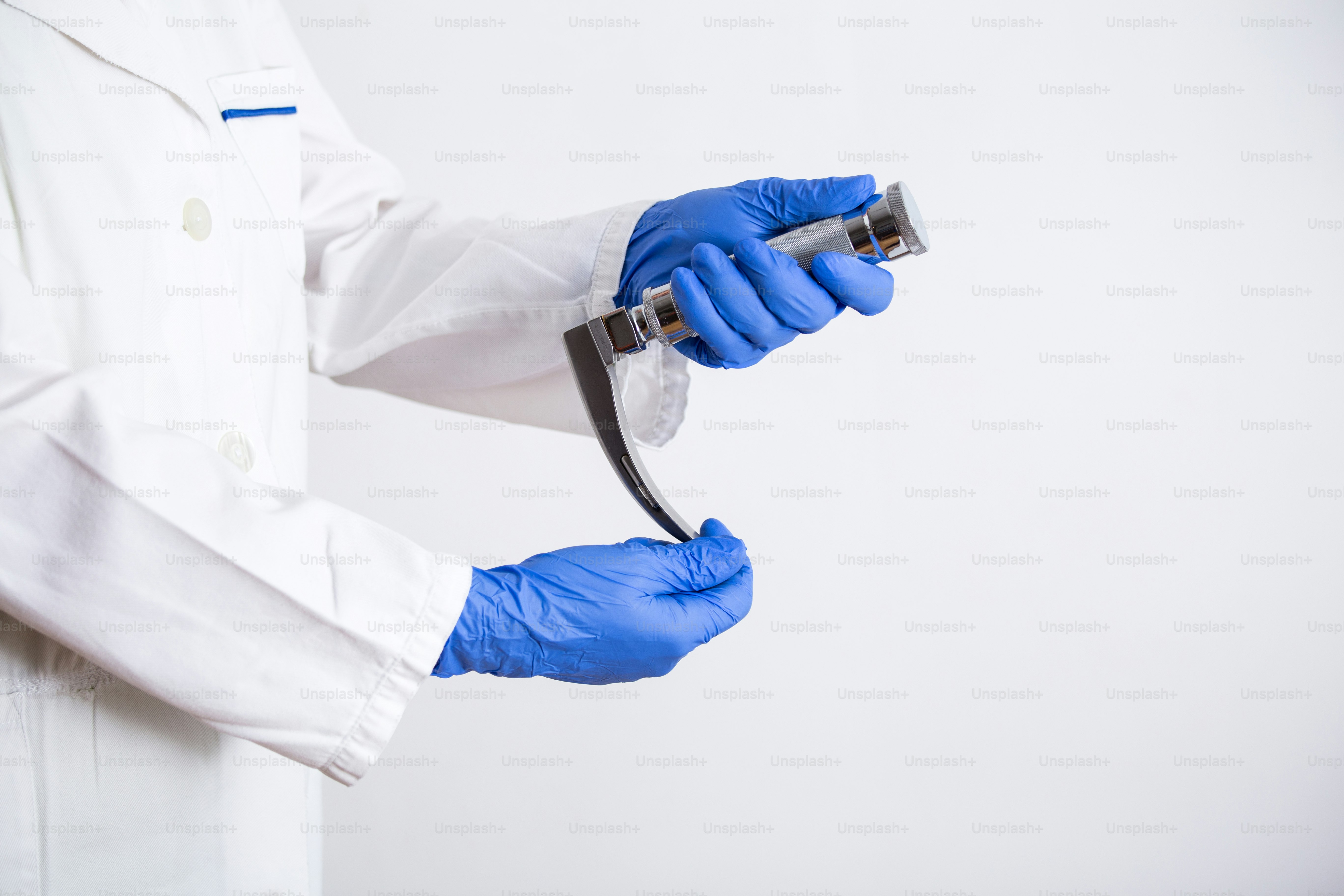 Hand's doctor holding laryngoscope, isolated on white background, copy