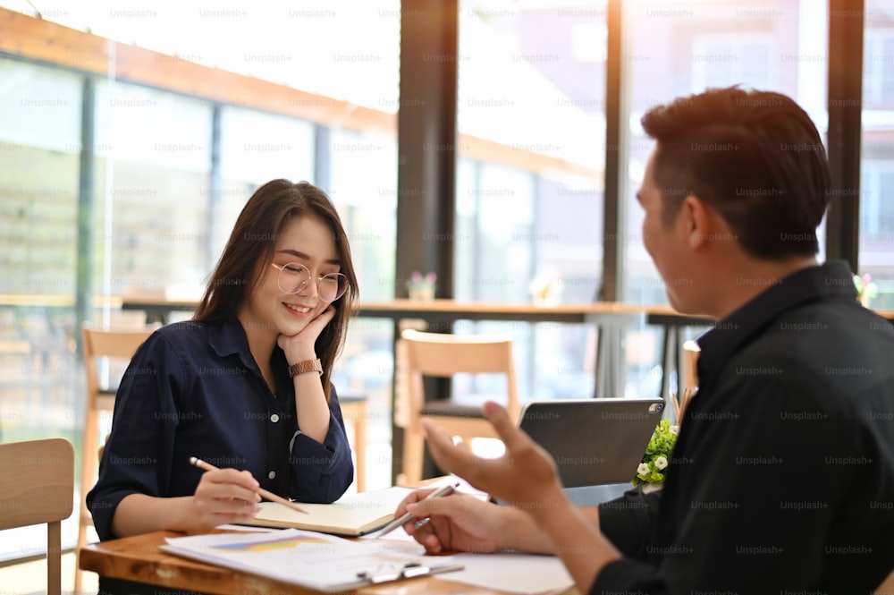 Woman and Man talking with business topic on office table.