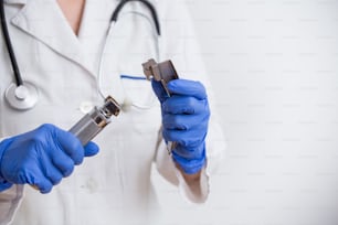 Hand's doctor holding laryngoscope, isolated on white background, copy space.