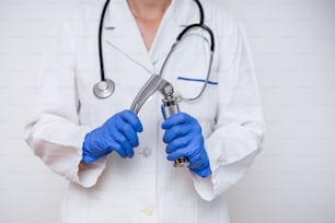 Hand's doctor holding laryngoscope, isolated on white background, copy space.