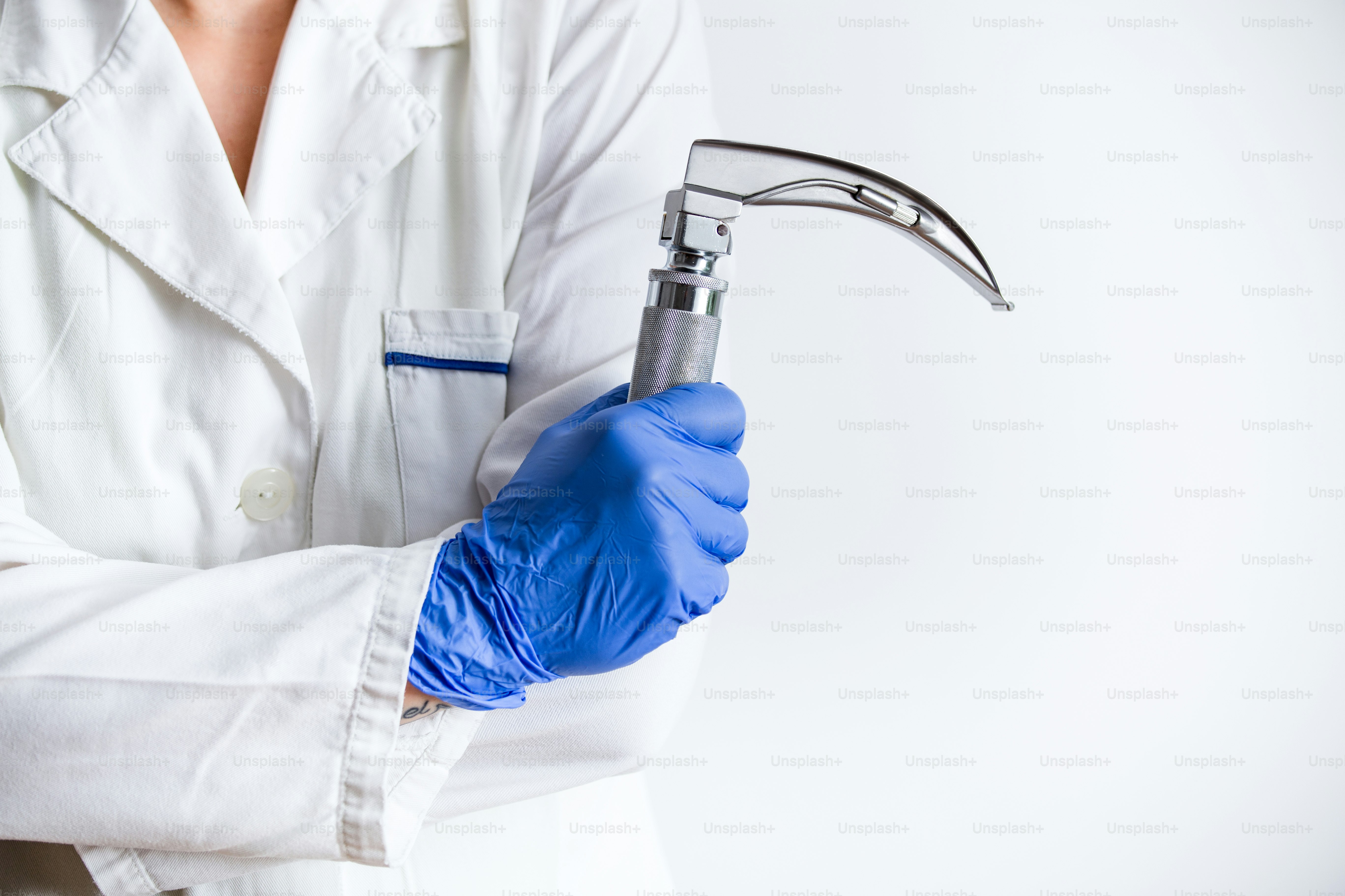 Hand's doctor holding laryngoscope, isolated on white background, copy space.