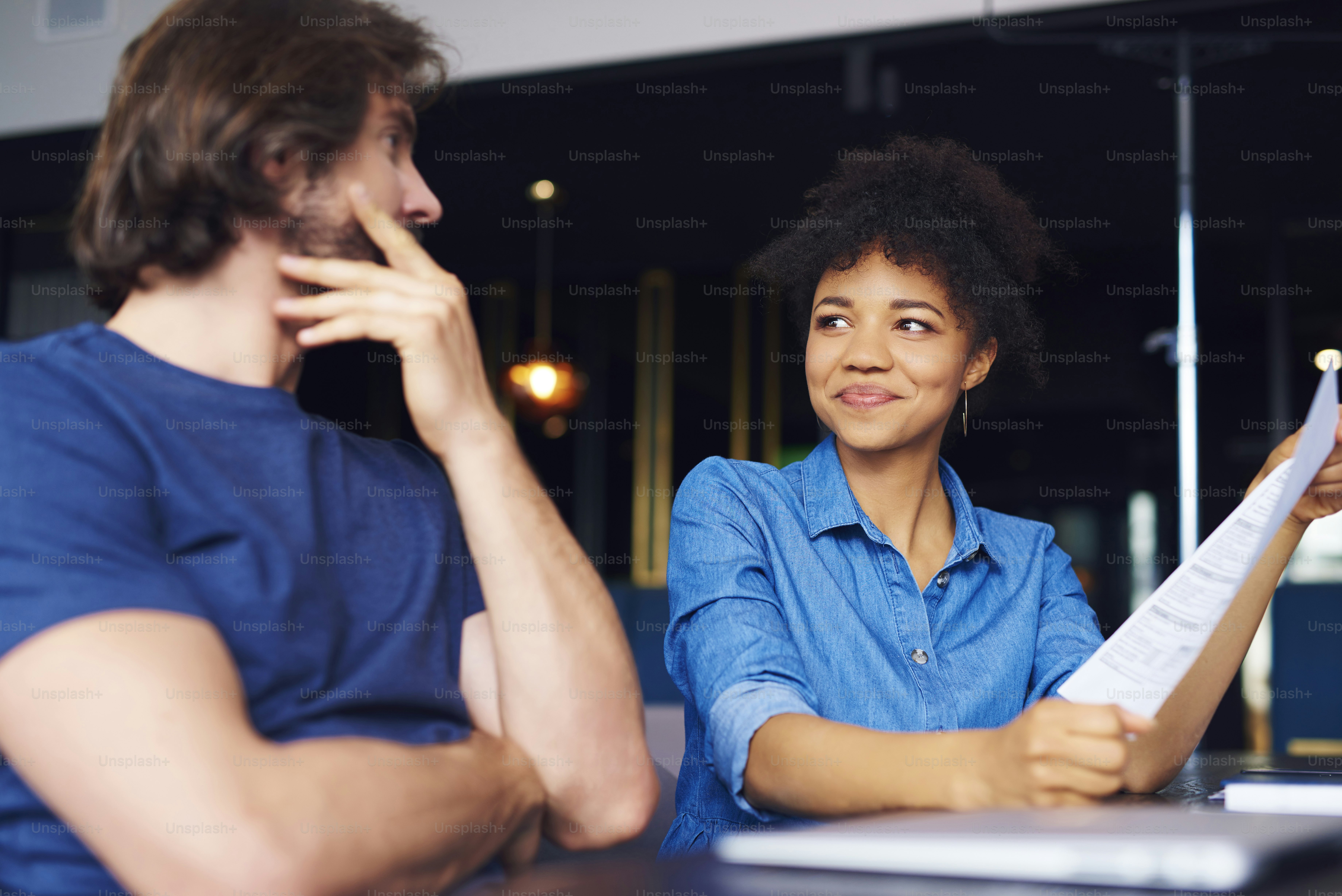 Young couple analyzing documents in the office