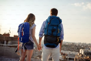 Young couple traveling with a map in the city
