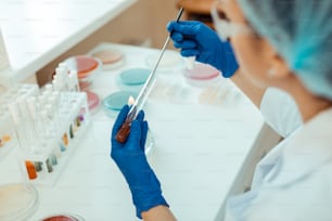 Experimental research. Top view of test tube with experimental vaccine while being taken for the analysis