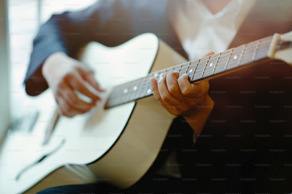 Cropped shot of man playing acoustic guitar.