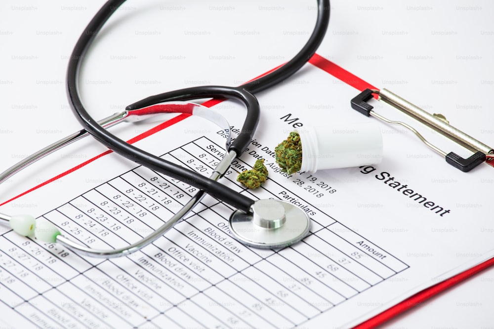 Medical Marijuana Close Up Cannabis Buds With Doctors Prescription For Weed. Medicinal Pot With Stethoscope. Selective Focus With Copy Space.