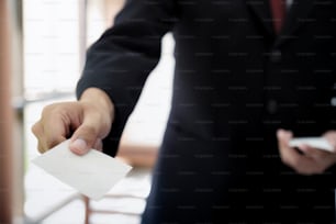 Businessman giving a business card. Business partners and colleague.