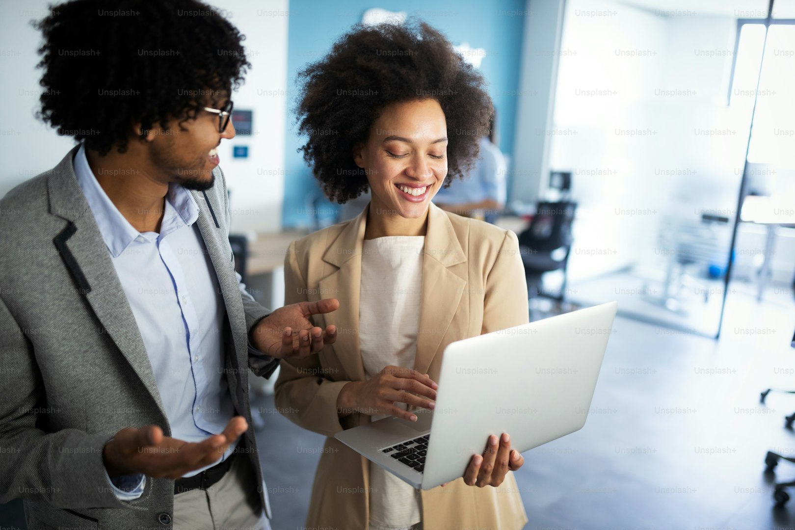 Black business couple collaborating in modern office