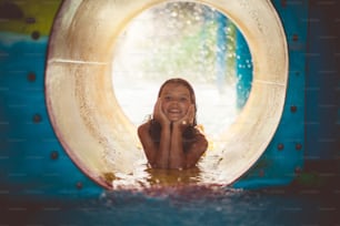 What is your favorite season? Child having fun on pool toboggan.