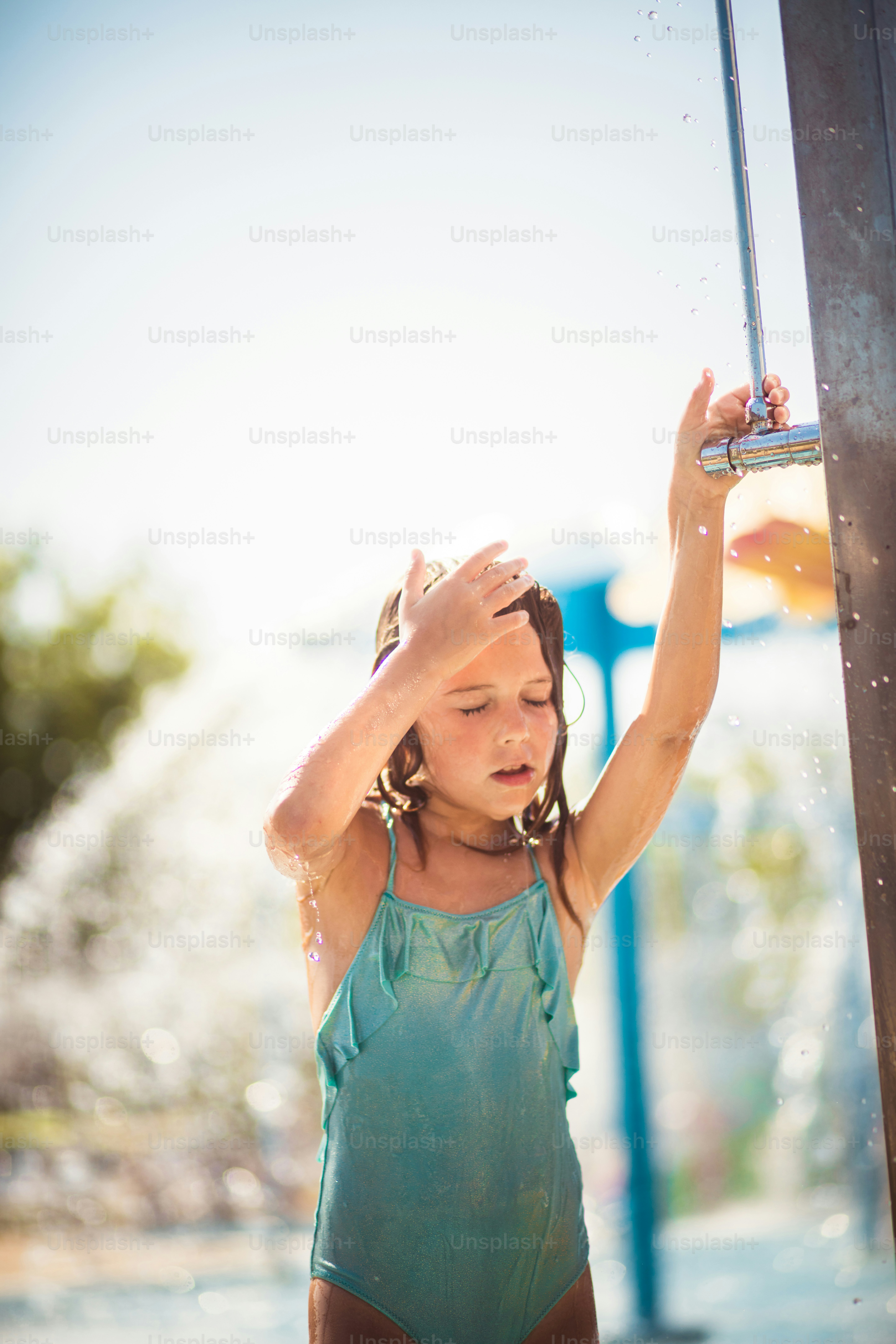 Sometimes the shower is good as a refreshment. Child showering. photo
