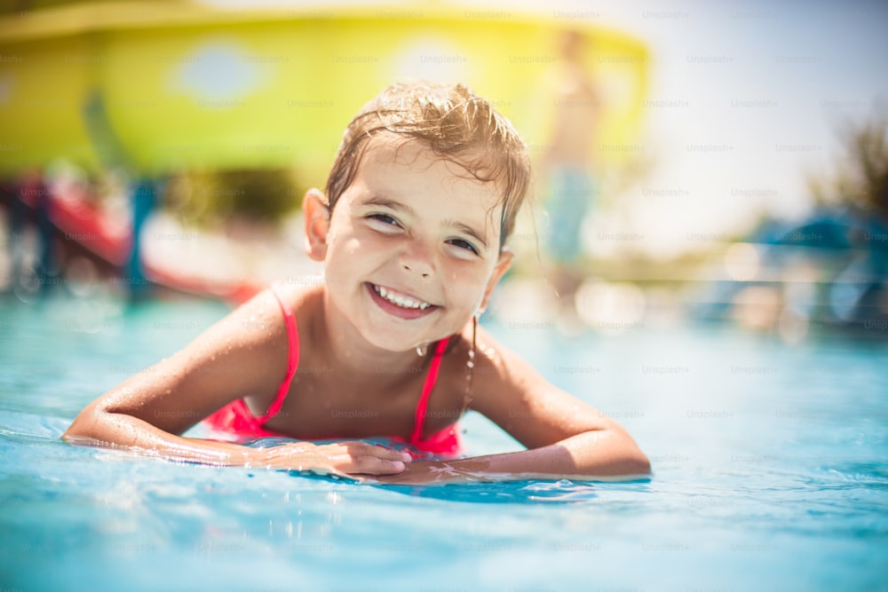 She's a true water girl. Child having fun in pool.