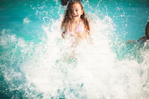 Waves is fun. Child having fun in the pool.