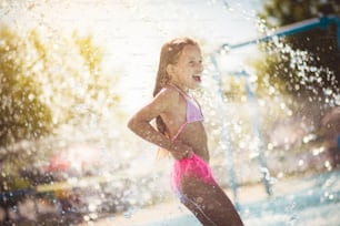 Summer girl. Child having fun in the pool.