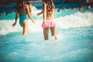 The summer brings us waves of fun. Children in pool.