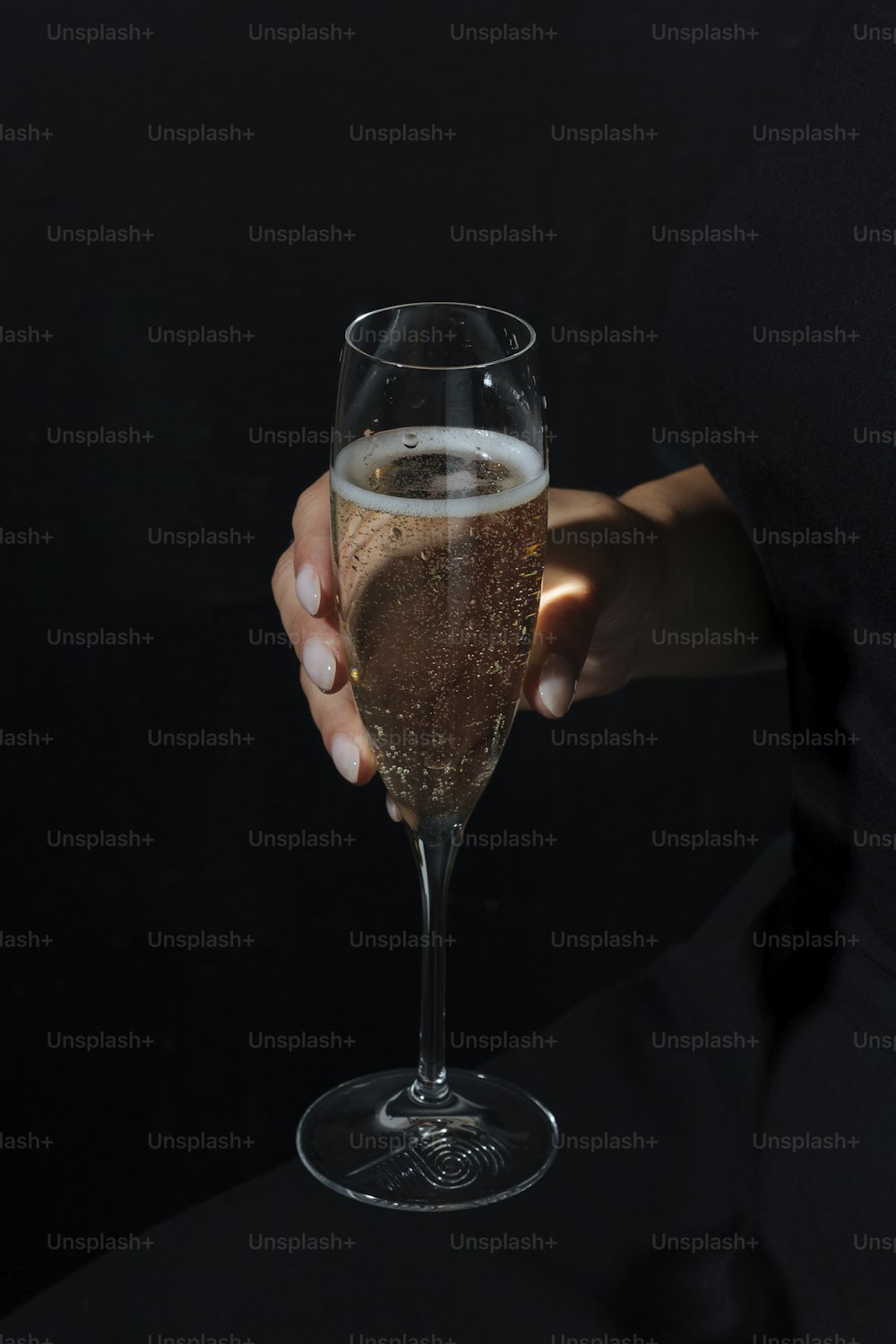 Woman helding a glass of Prosecco, an italian sparkling wine, dark and moody