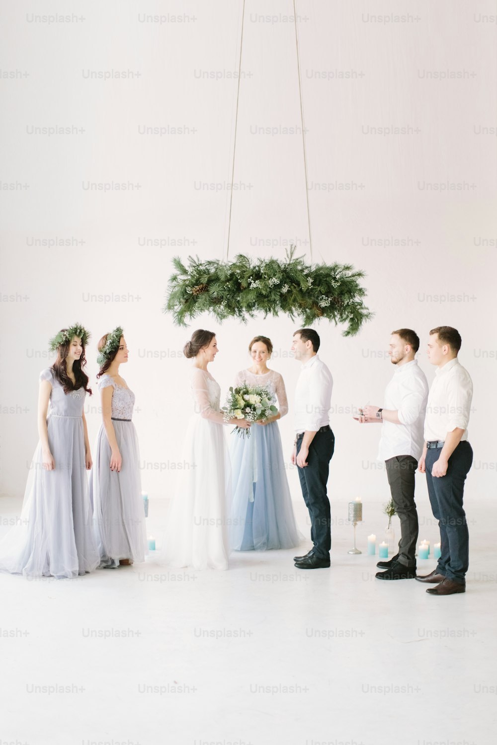 bride and groom holding hands at wedding ceremony indoors. ceremony master performing speech