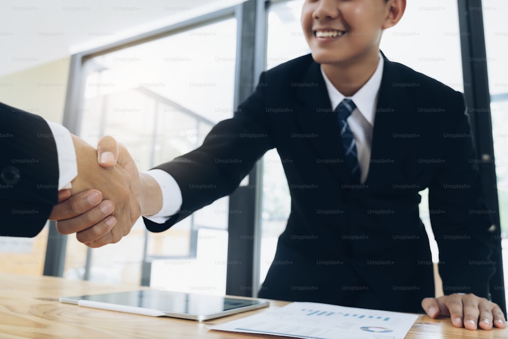 Businessmans handshake. Successful businessmen handshaking after good deal. Business partnership meeting concept.