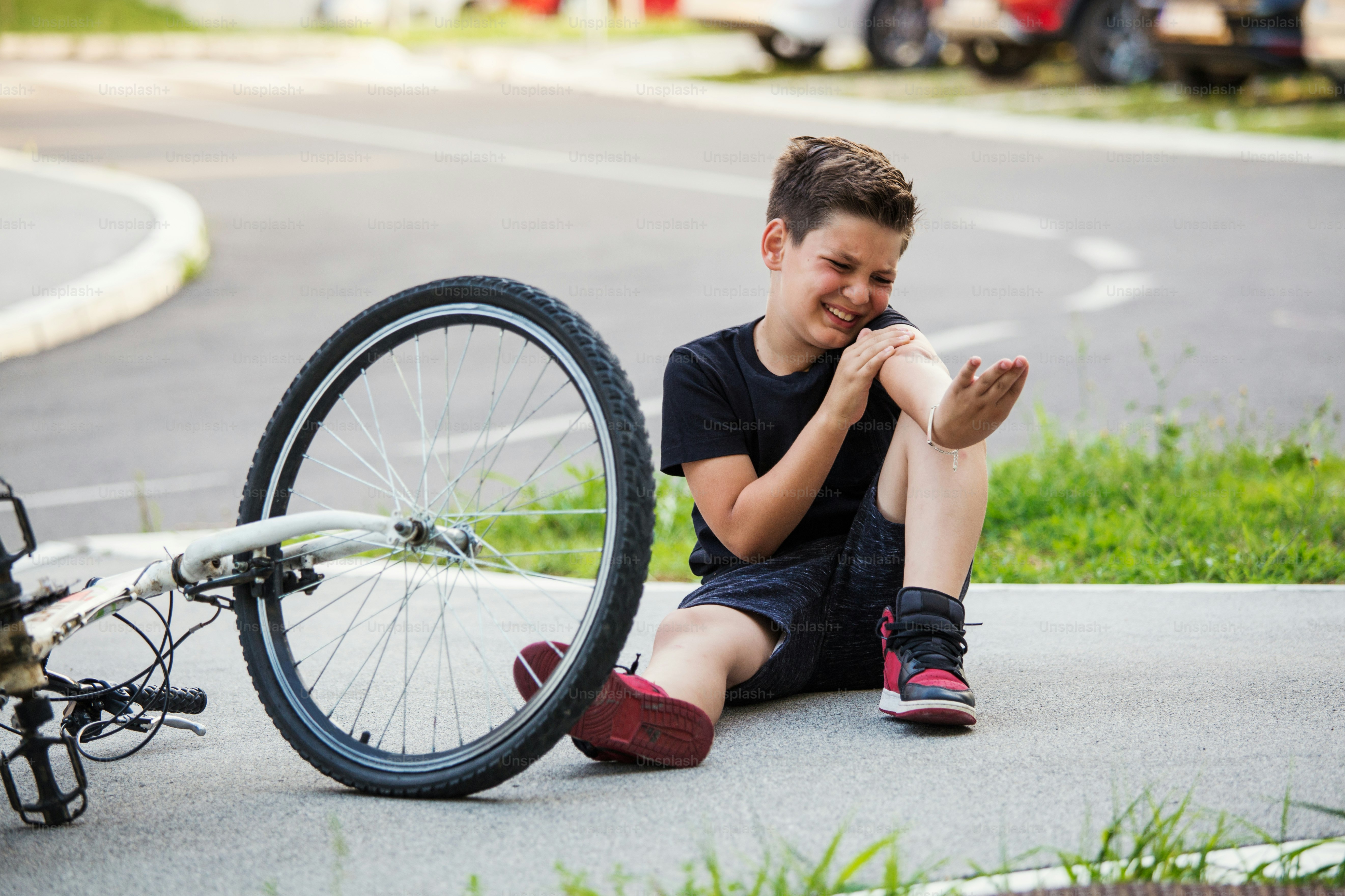 Teenage boy There is a elbow injury, as the bike falls while riding. Kid hurts his arm after falling off his bicycle. Child is learning to ride a bike