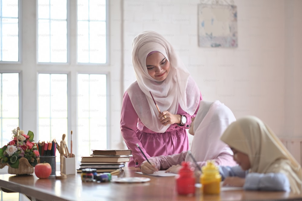 Asian muslim girls learning painting in class
