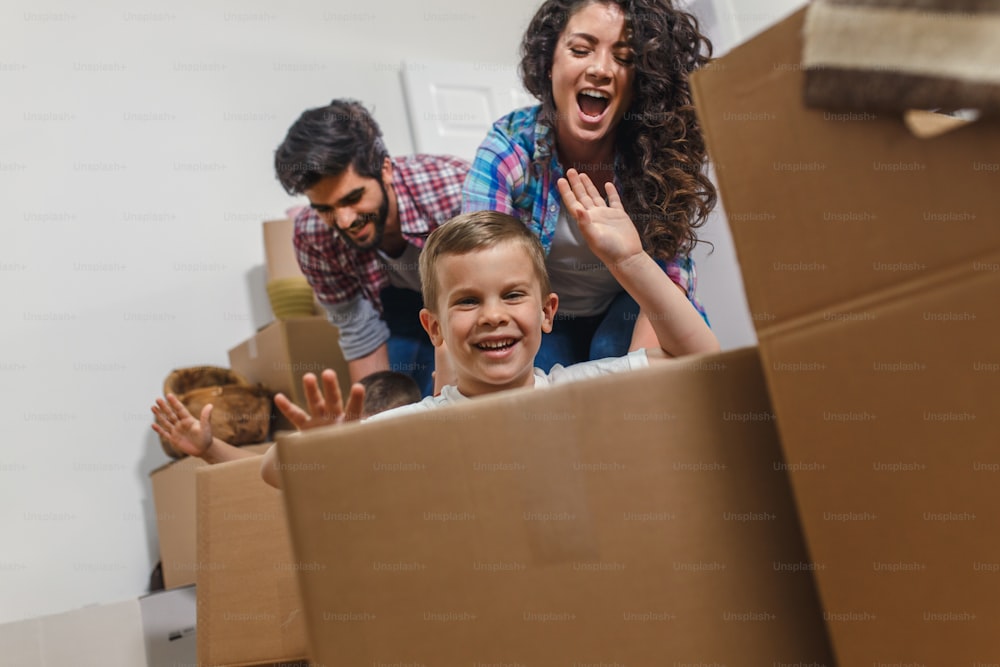 Happy young family having fun while moving into their new home.