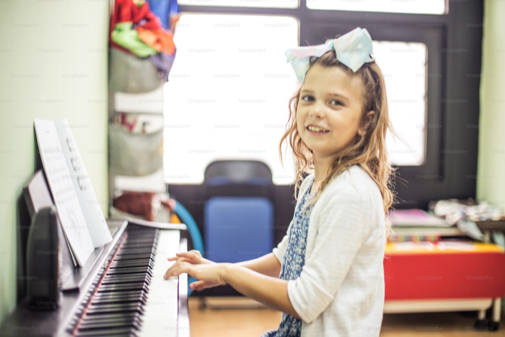 I love playing the piano. Little girl playing piano.