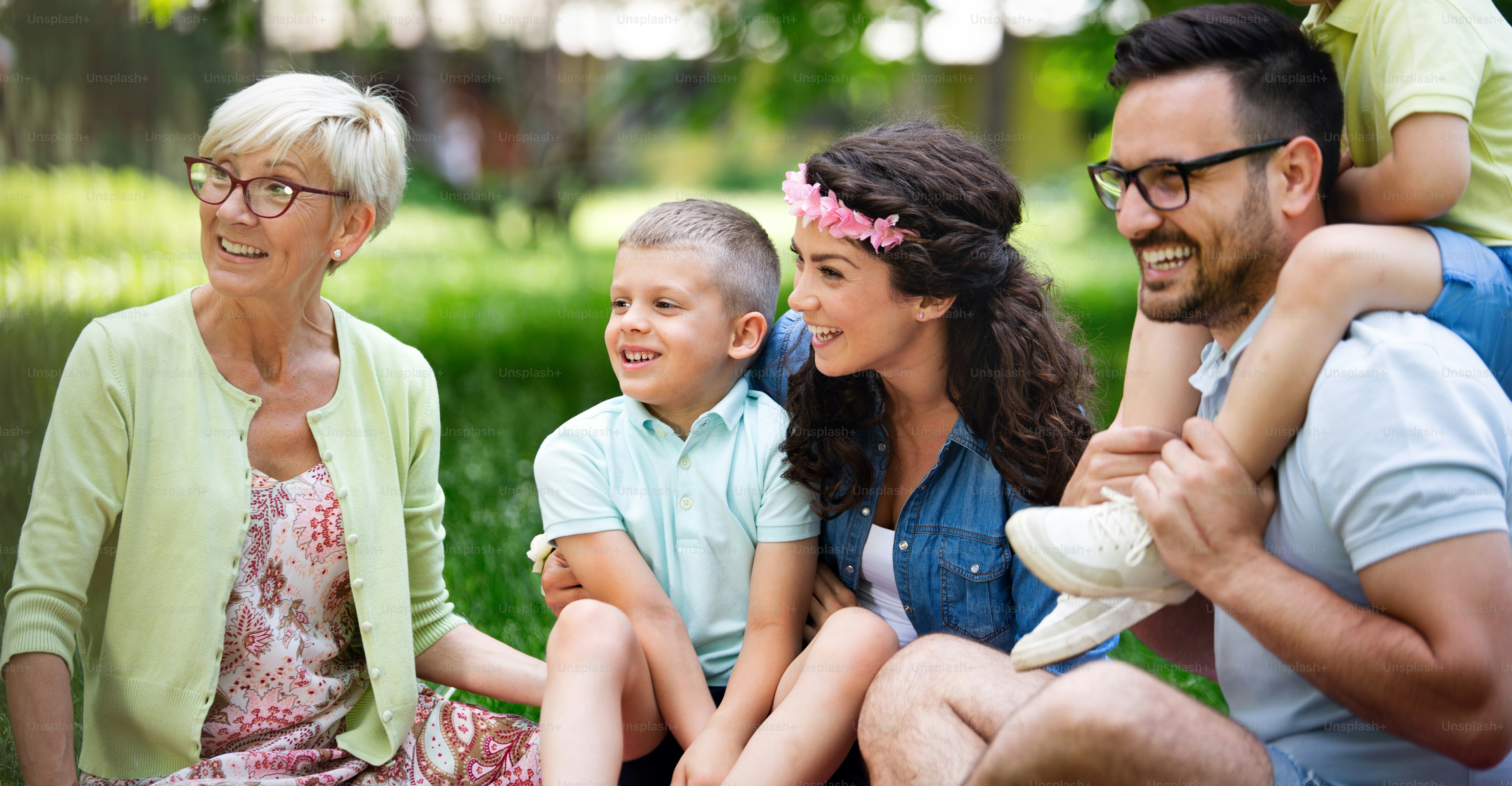 Happy family enjoying picnic in nature with grandparent