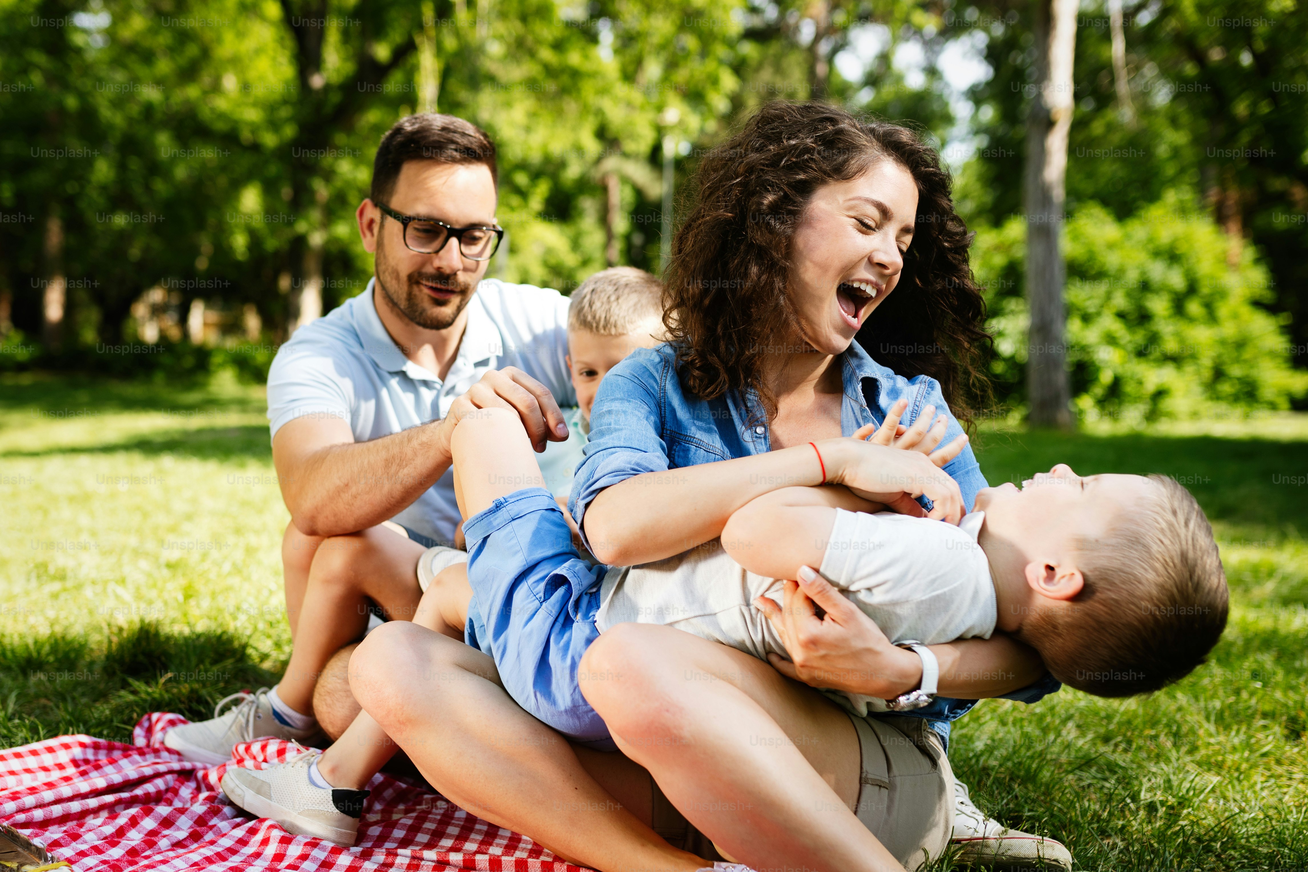 Young happy family with children having fun in nature
