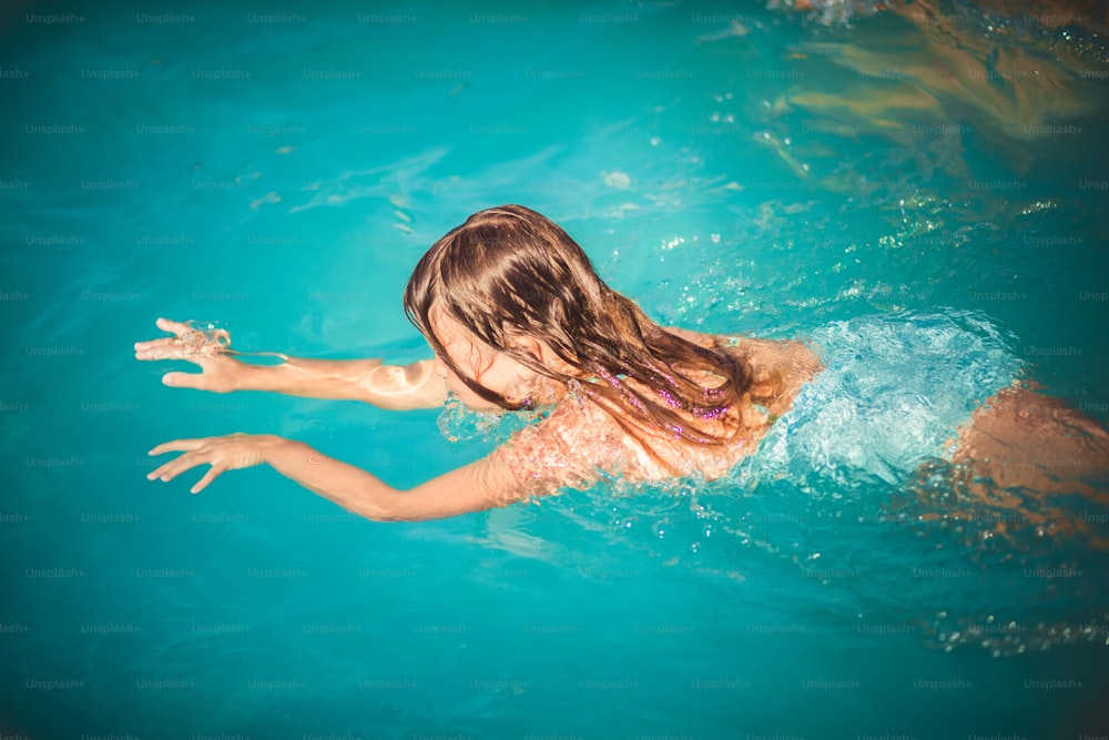 Water is a way to relax. Child in the pool.