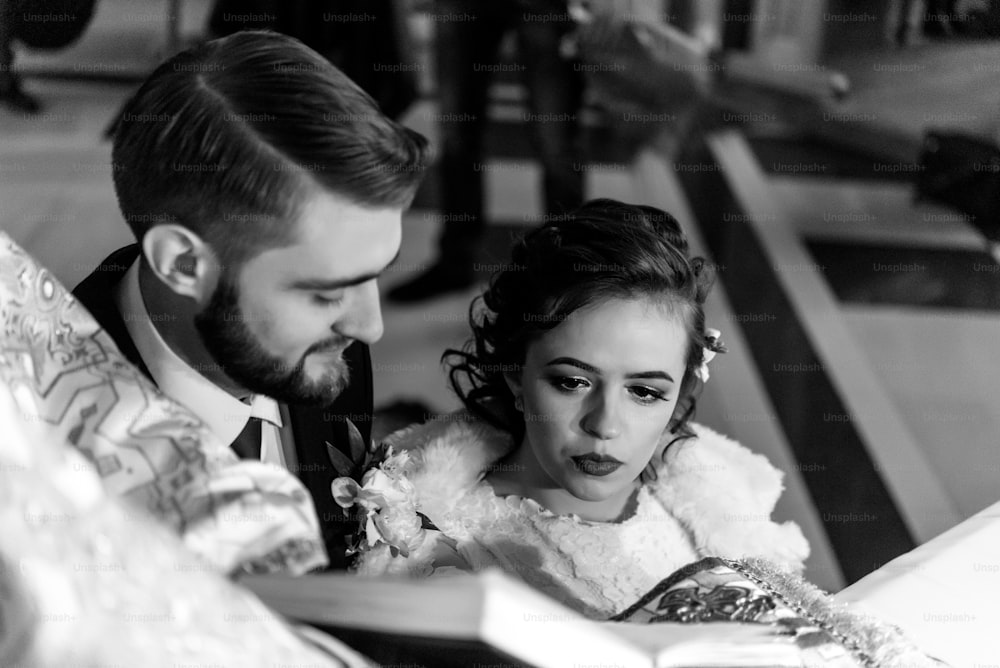 stylish luxury bride and elegant groom, making oaths, emotional traditional  wedding ceremony