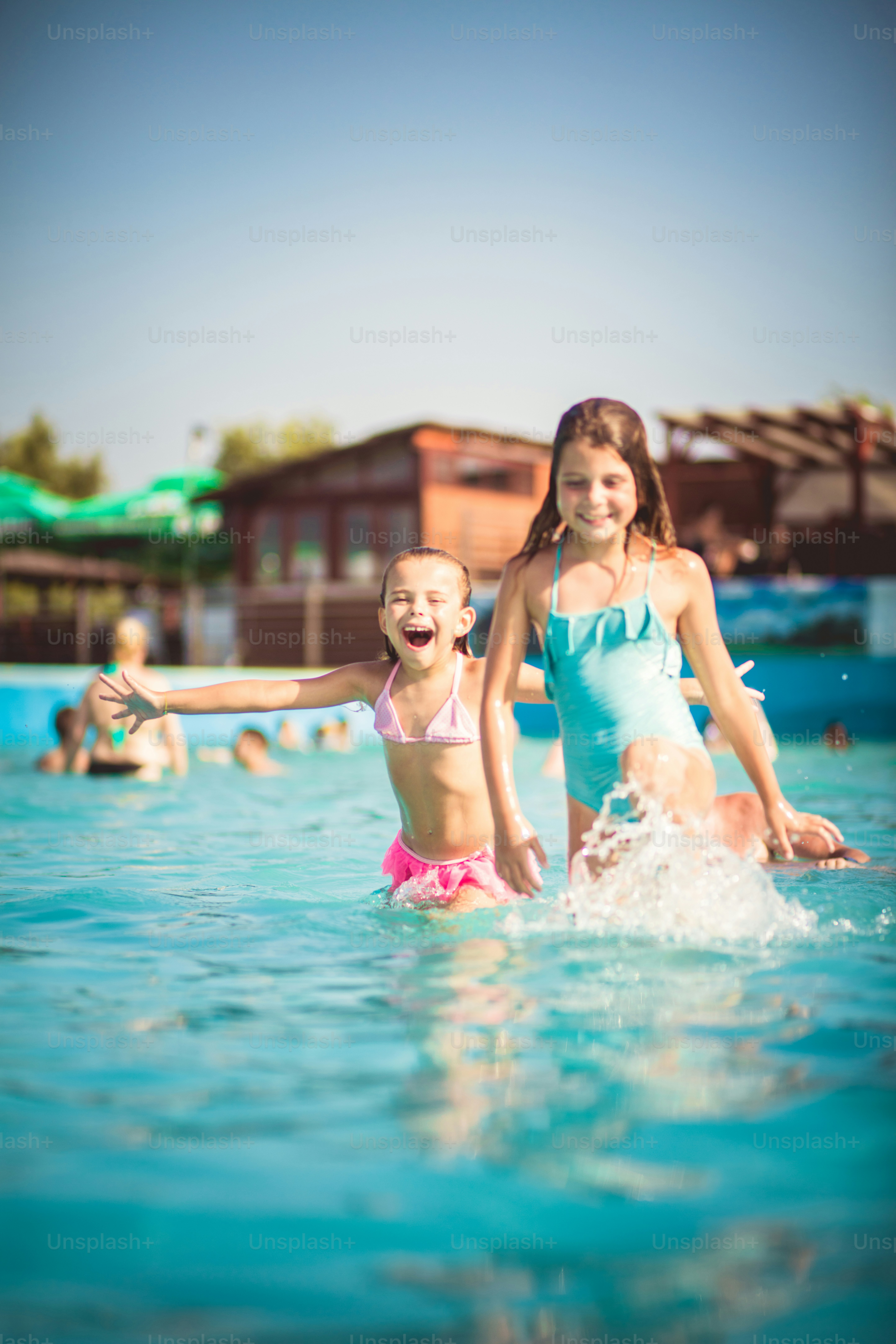 Always fun. Two little girl playing in the pool. photo – Water Image on ...