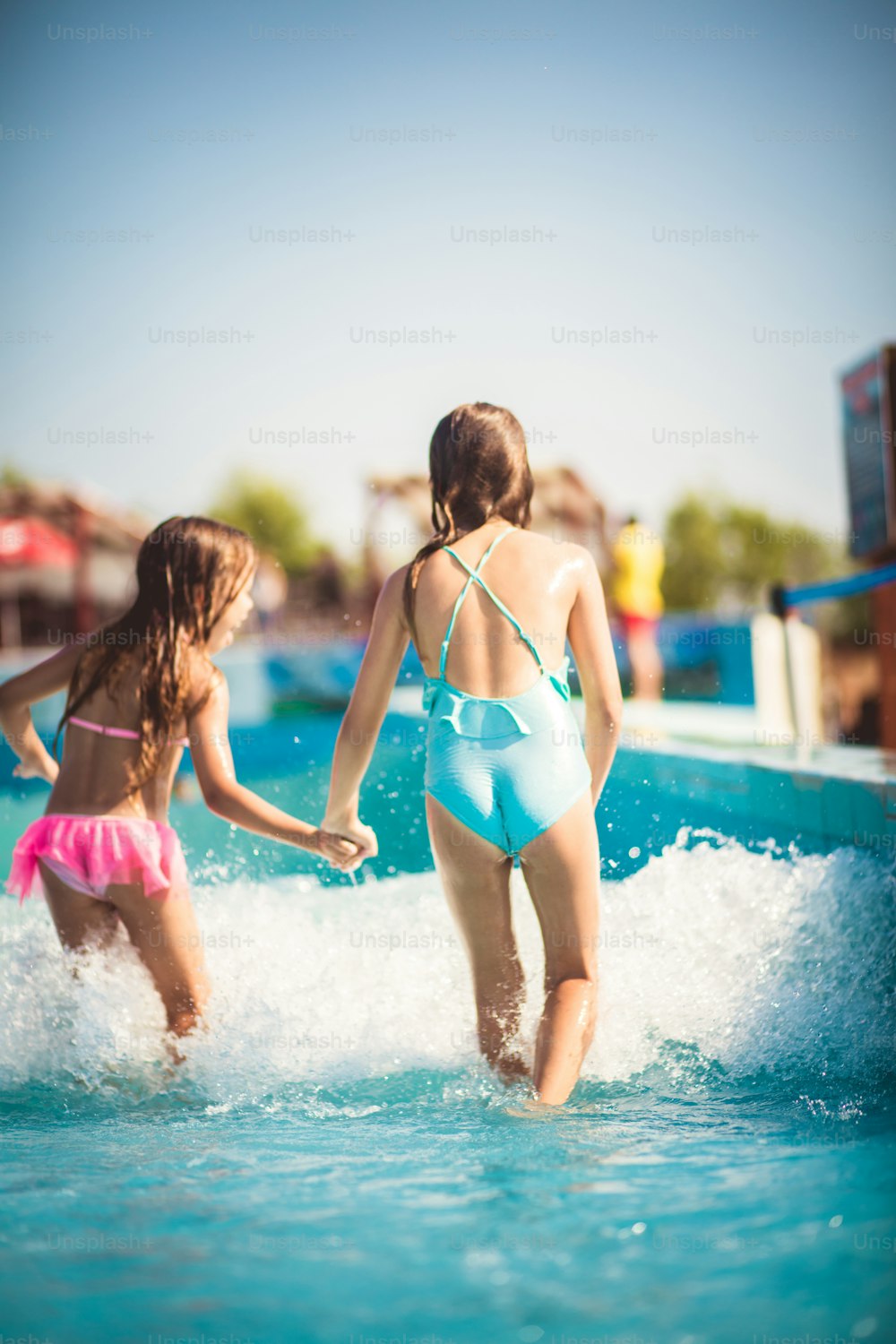 Water waves. Children in pool.