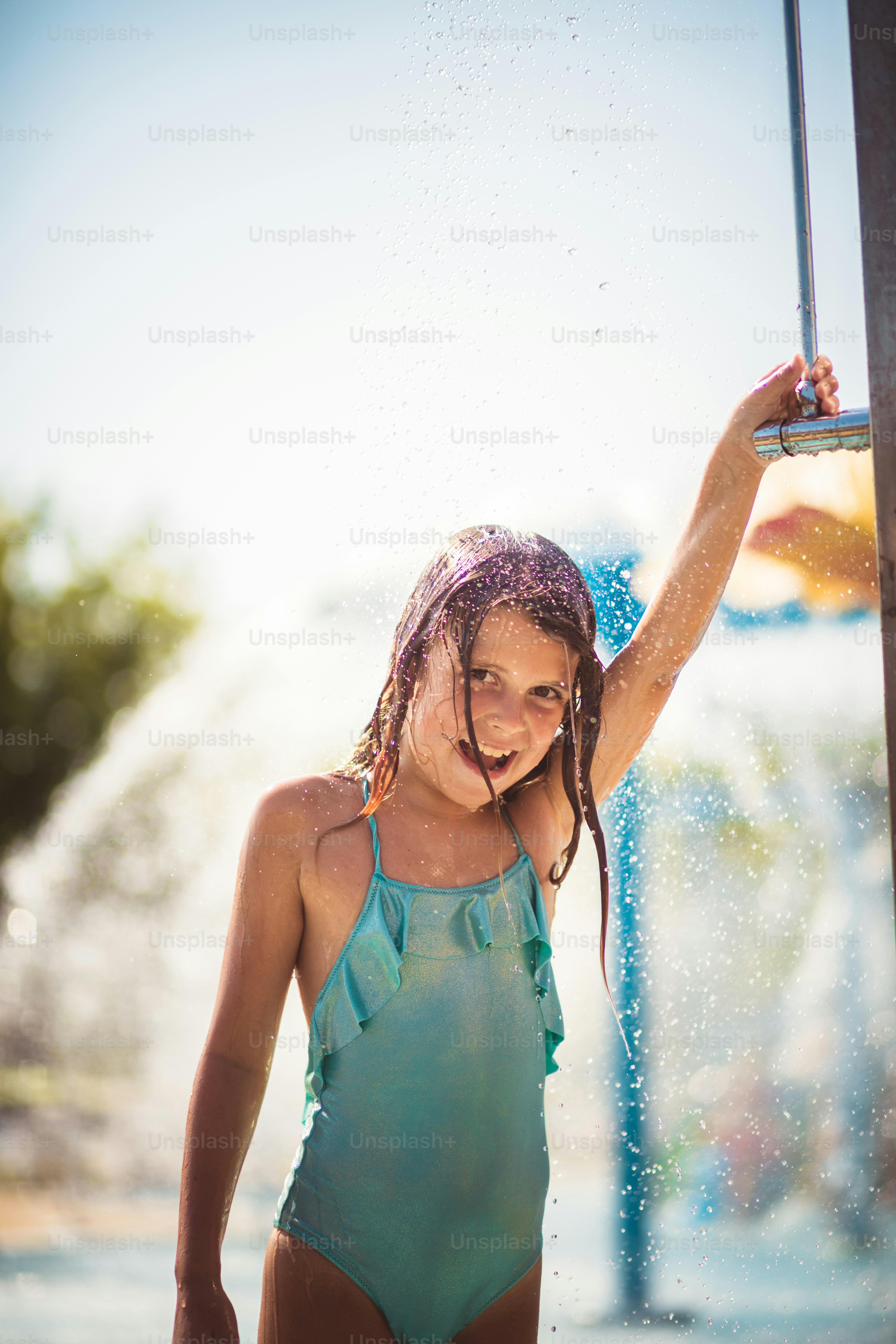 Refreshing moment. Child showering after pool. photo Water Image on