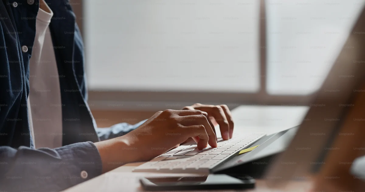 Unsplash Main Using Computer Cropped shot man using computer with typing computer keyboard. photo ...