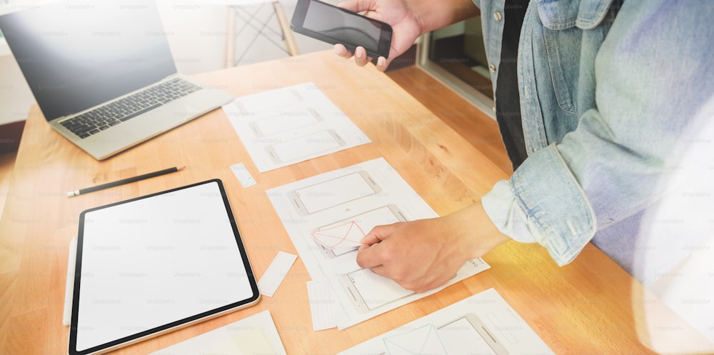 UI UX graphic designer sketching and planning application