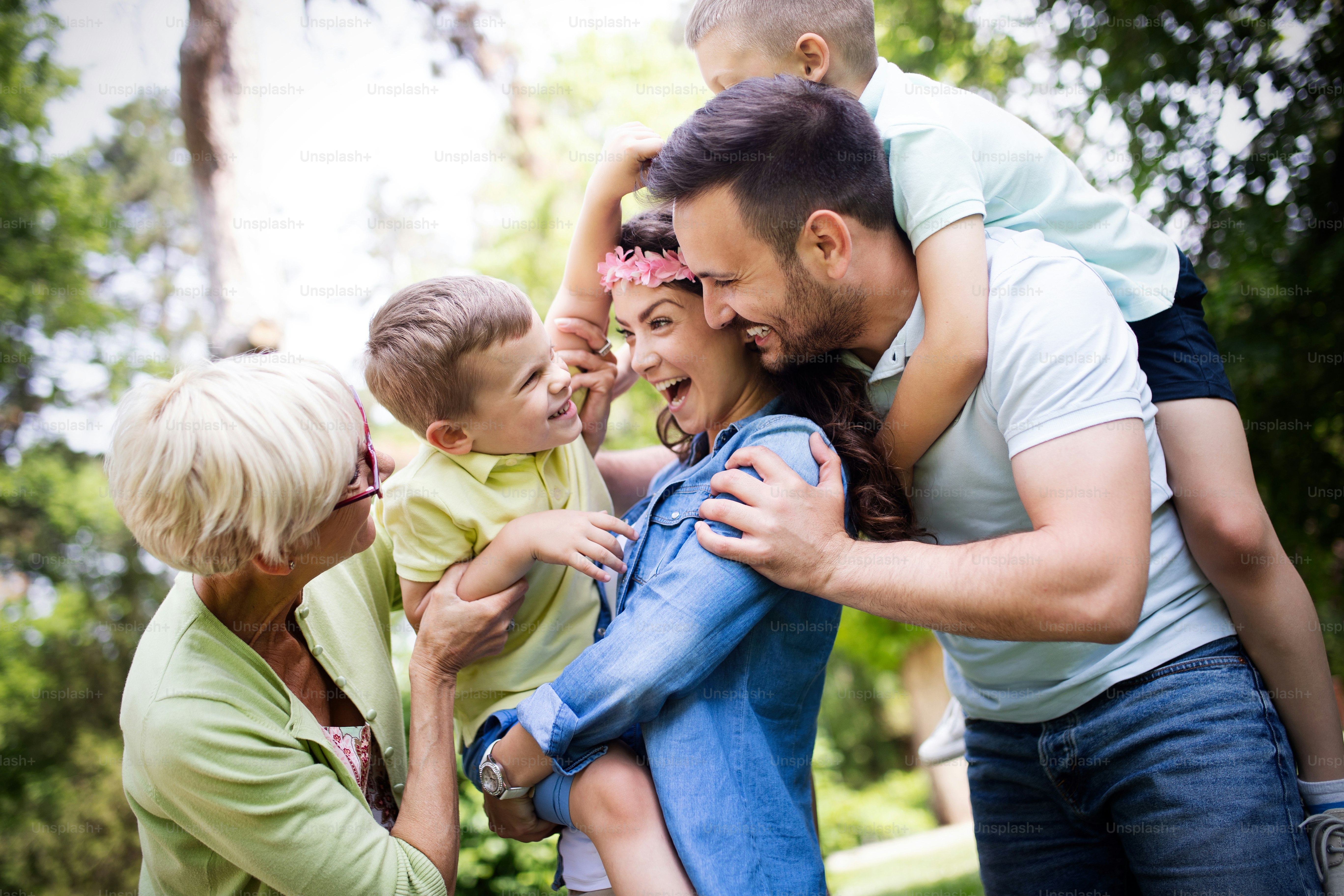 Happy family enjoying picnic in nature with grandparent