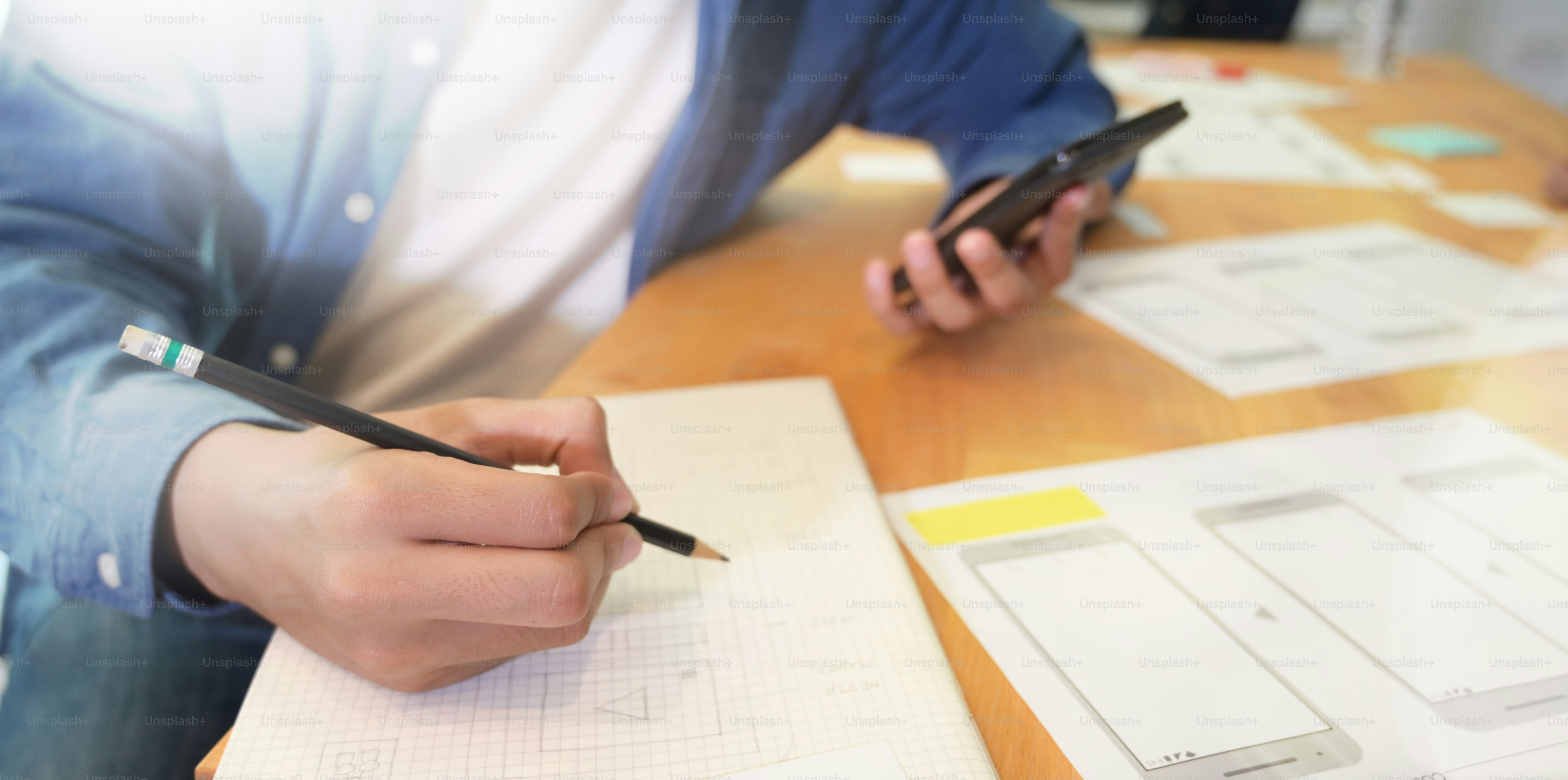 Young male designer working on website UX app development, Close-up view