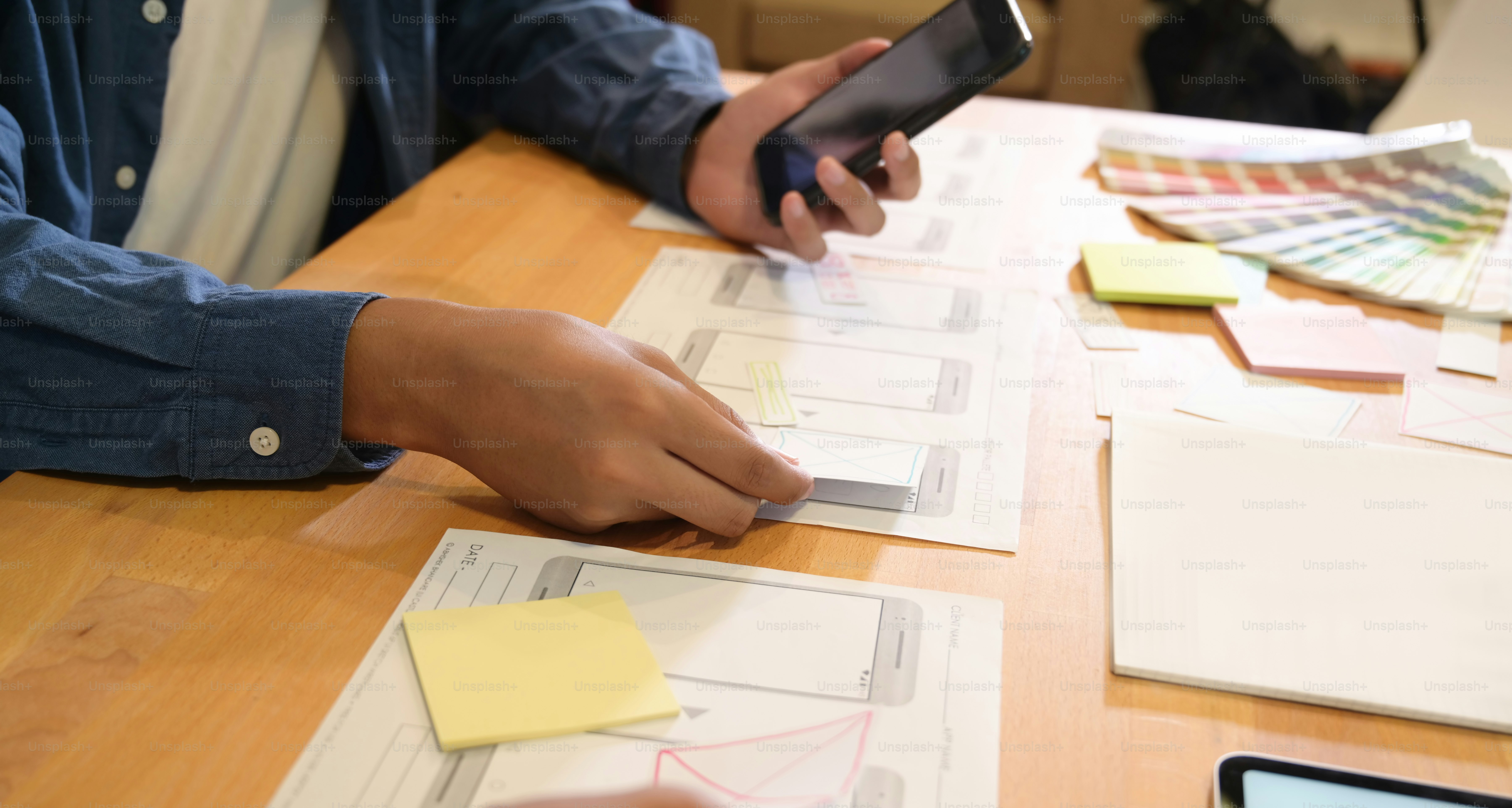 Young professional male UI developer designs UI template in work space