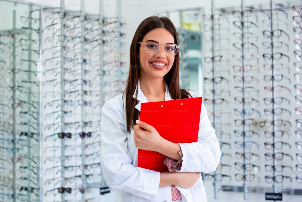 smiling ophthalmologist standing with diagnosis in clinic