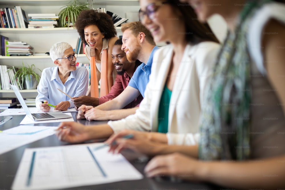 Group of successful happy business people at work in office