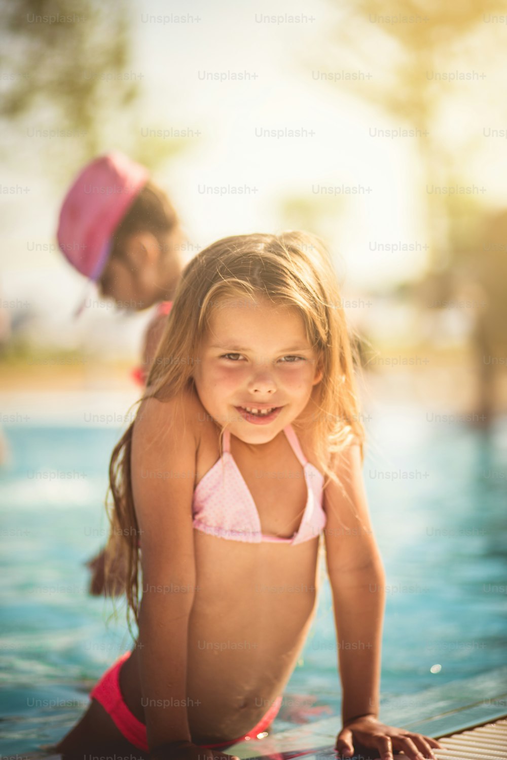 Summer season is start. Little girl standing in the pool.